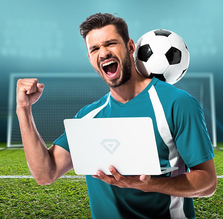 Man on the football field holding laptop with GemBet logo